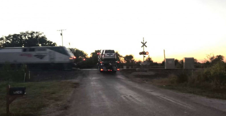 Dramatic video shows Amtrak train slamming into semi-truck car hauler